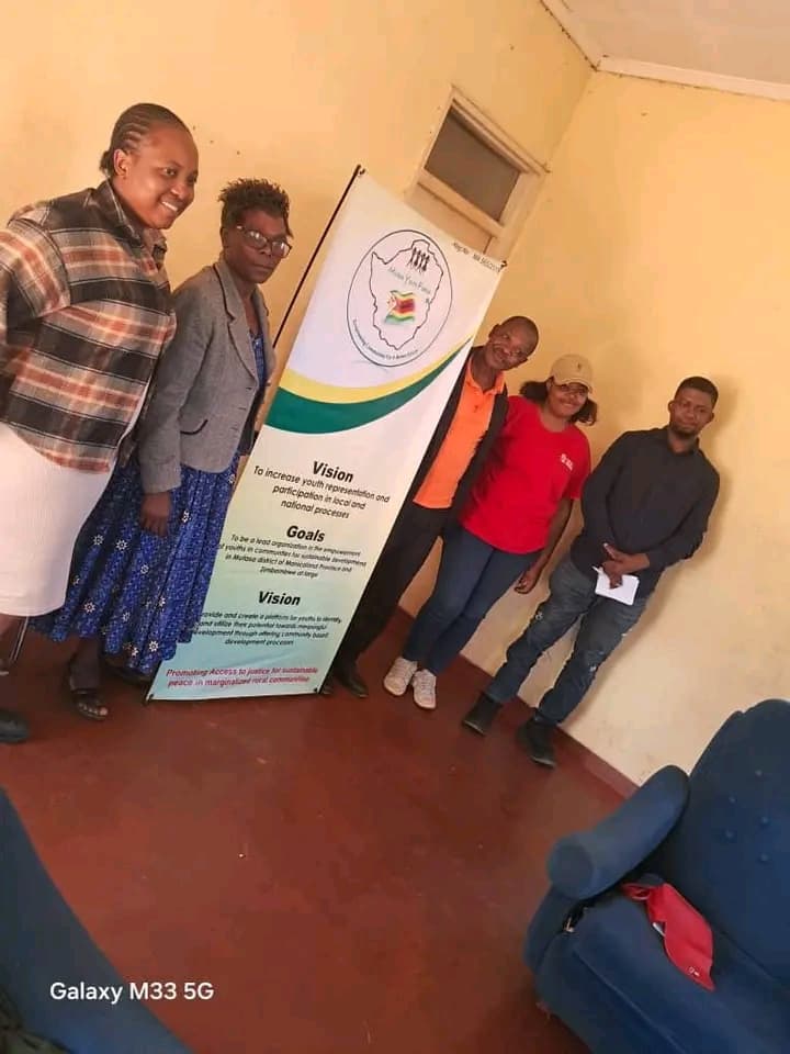 Mutasa Youth Forum team with organisational banner showing vision, mission and goals